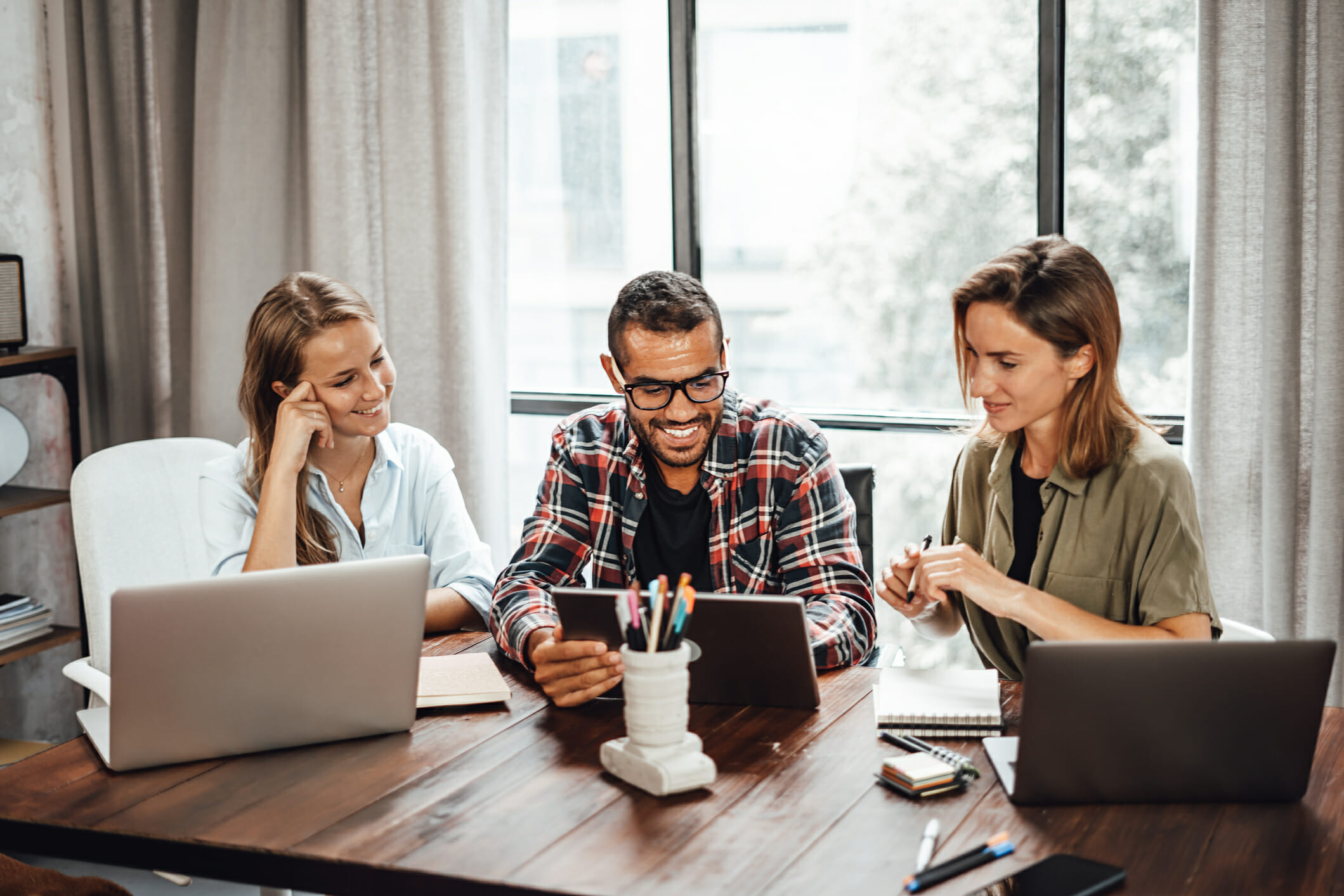 Group of young people working or studying together. Hipster team in coworking. Young modern business colleagues. Teamwork. Startup concept