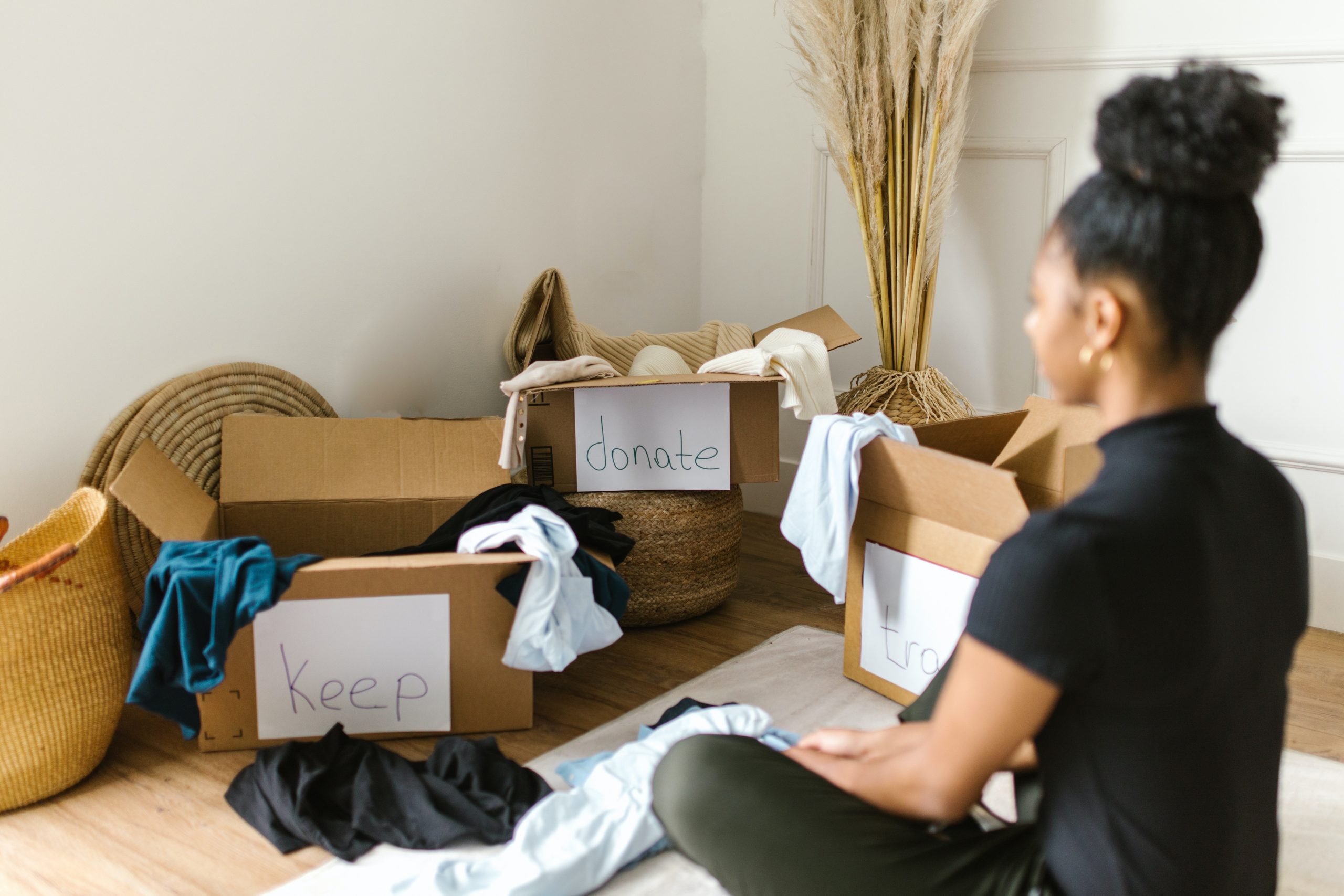 Chica evaluando y purgando sus pertenencias para organizar su espacio